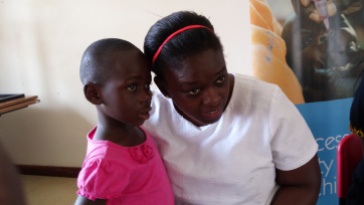 Giving a listening ear to one of the children at SOS Children's Village Entebbe.